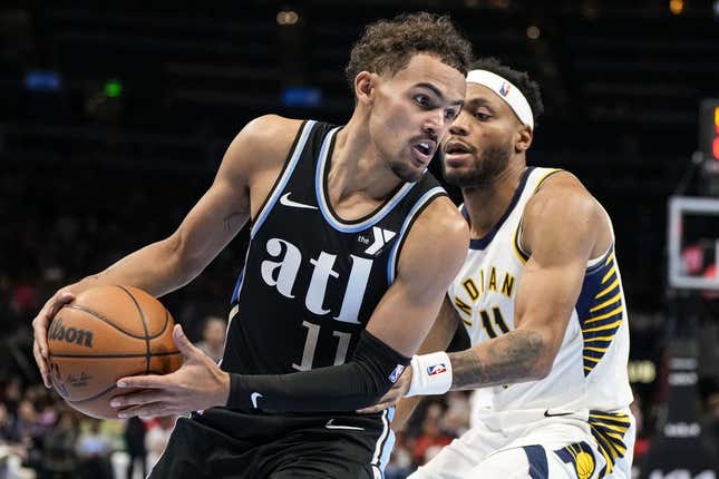 Nov 21, 2023; Atlanta, Georgia, USA; Atlanta Hawks guard Trae Young (11) tries to get past Indiana Pacers forward Bruce Brown (11) during the second half at State Farm Arena.