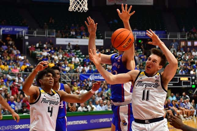 Nov 21, 2023; Honolulu, HI, USA; Kansas Jayhawks forward Parker Braun (23) fought for a rebound with Marquette Golden Eagles guard Stevie Mitchell (4) and guard Tyler Kolek (11) during the first period at SimpliFi Arena at Stan Sheriff Center.