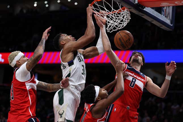 WASHINGTON, DC - NOVEMBER 20: Giannis Antetokounmpo #34 of the Milwaukee Bucks dunks on Kyle Kuzma #33, Bilal Coulibaly #0 and Deni Avdija #8 of the Washington Wizards during the second half at Capital One Arena on November 20, 2023 in Washington, DC. NOTE TO USER: User expressly acknowledges and agrees that, by downloading and or using this photograph, User is consenting to the terms and conditions of the Getty Images License Agreement.  (Photo by Patrick Smith/Getty Images)